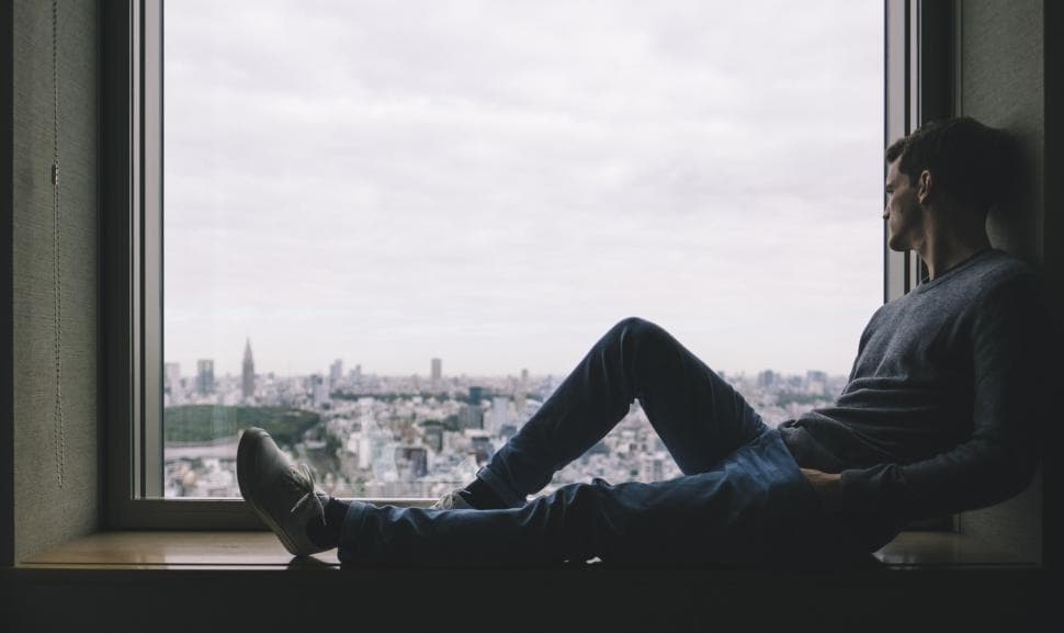 alone-man-sitting-at-window-