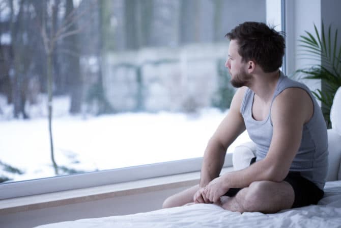 lonely-man-looking-out-window-670x447