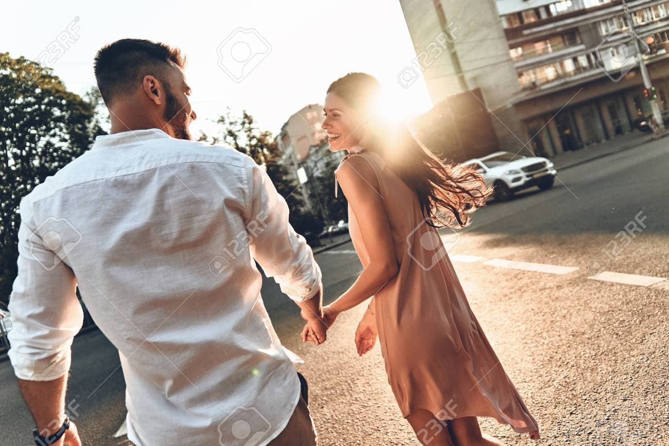 88798361-happy-to-be-together-rear-view-of-beautiful-young-couple-holding-hands-and-looking-at-each-other