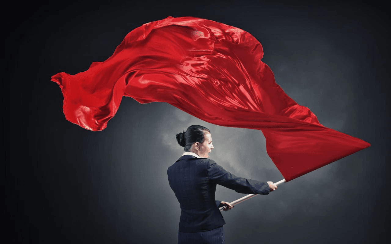 business-woman-waving-red-flag-xlarge